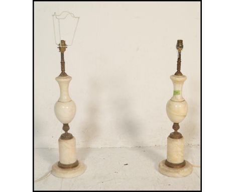 A 20th Century alabaster / marble table lamp of baluster form set to a square base together with a matching pair of garniture