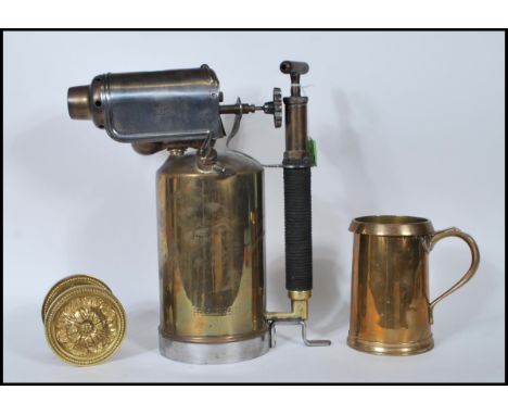 A Georgian 19th Century brass tankard / measure of large form having shaped handle and impressed marks to side G R 523 LCC 11