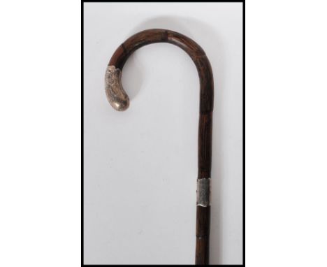 A early 20th Century bamboo walking stick cane having a silver hallmarked collar and knop with engraved foliate decoration. H