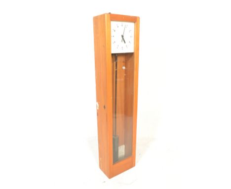 A vintage factory 'pul-syn-thetic' slave clock impulse pendulum wall clock of rectangular form having a glazed door to the fr