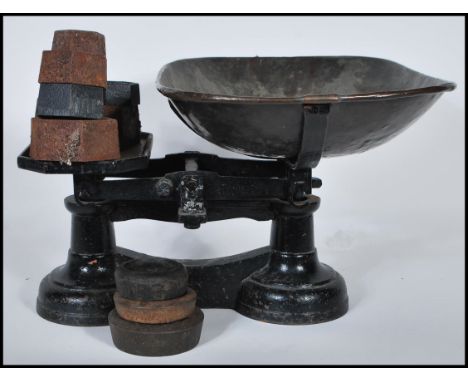 Vintage traditional balance weighing scales. Cast iron with copper bowl plus eleven weights.