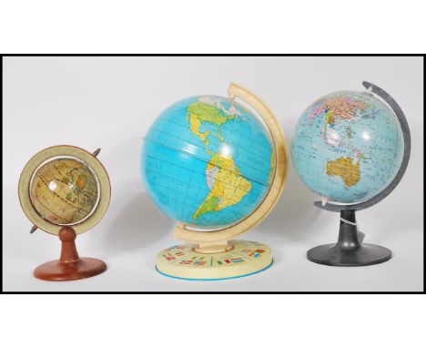 A selection of vintage desktop globes to include a 1970's Georgian style desk globe raised on a circular wooden base and two 
