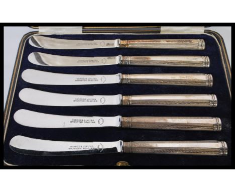 A cased set of silver hallmarked Harrods of London fruit / butter knives complete in the presentation case. Hallmarked for 19