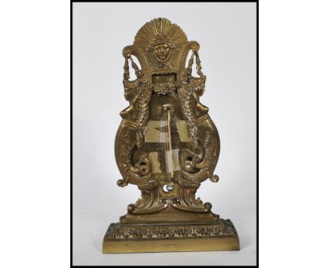 A early 19th Century Georgian brass desk thermometer decorated with mermaids to both sides with floral garlands, having class