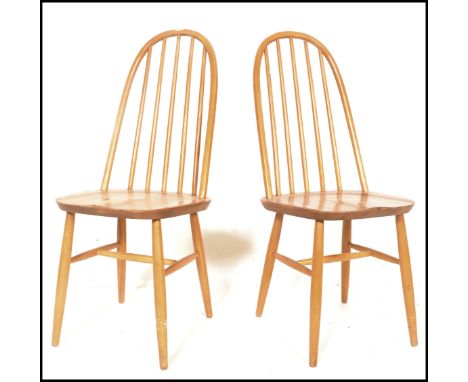 A pair of 20th Century Ercol Windsor style Priory Quaker hoop-back dining chairs in light elm, raised on tapering legs. Measu