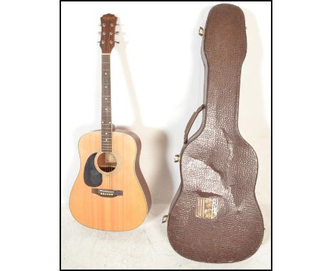 A 20th Century left handed six string acoustic guitar by Freshman Avalanche model FA100SATLH, having a shaped hollow body wit