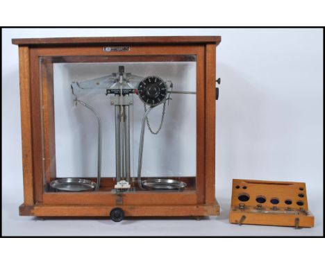 AN early 20th Century mahogany glazed cased apothecary / chemists scales by Griffin and George, together with a cased set of 