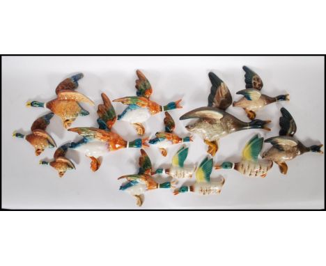 A collection of vintage ceramic duck wall plaques to include four graduating Beswick ducks, three SylvaC ducks and a selectio