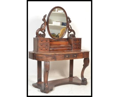 A Victorian mahogany duchess dressing table raised on turned supports with serpentine shaped dressing table having trinket dr