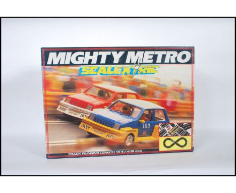 A vintage Scalextric slot car racing set ' Mighty Metro '. Appears complete, including both cars. Within the original box. Us