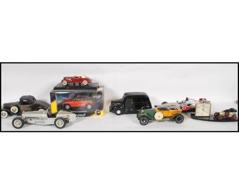 A collection of model scale diecast cars to include McLaren F1 car, Mini Cooper, Franklin Mint 1914 Rolls Royce, Bburago Buga