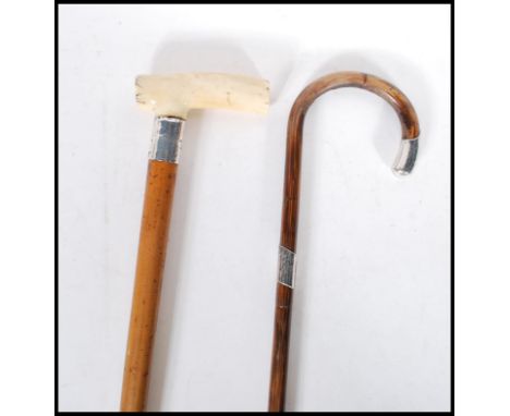 A malacca walking stick cane having a silver collar and bone handle to the top along with a bamboo walking stick with curved 