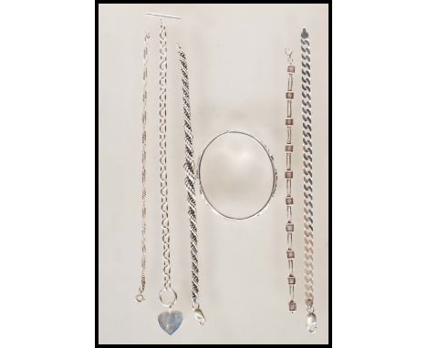 A selection of stamped 925 silver bracelets to include a bangle having raised floral decoration, a heart toggle clasp bracele