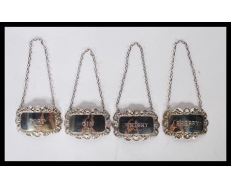 A set of 4 silver hallmarked decanter labels to include Whisky, Gin, Sherry &amp; Port. Hallmarked for London for 1971 by DJ 