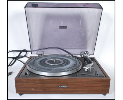 A vintage Pioneer PL 120 record player having a belt drive turntable, with overhang checker and anti-skating, within a teak c