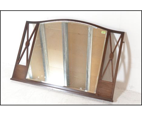 An early 20th Century Edwardian mahogany inlaid arched overmantel wall mirror, central bevelled mirror panel flanked by pierc