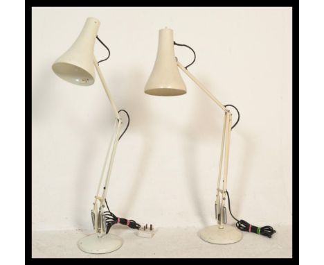 Two vintage retro Herbert Terry 20th Century anglepoise table desk lamps raised on circular bases with iconic conical pendant