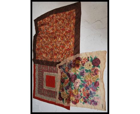 A group of three vintage early 20th Century designer silk scarves to include two by Liberty and Co London and one by Jacqmar.