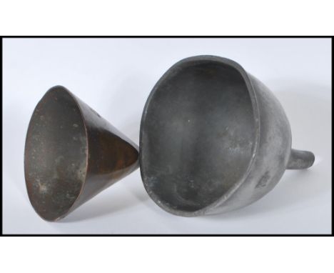 A 19th Century Georgian pewter wine funnel marked International Stores along with another copper wine funnel.&nbsp;