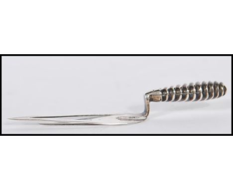 A silver hallmarked novelty bookmark modelled as a trowel, Birmingham assay marks. Measuring 7cm in length and weighing 3.1g