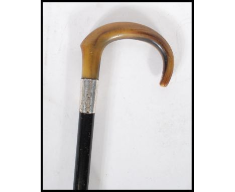 A early 20th Century 1920's silver&nbsp;collared promenade walking stick cane having horn crook handle with ebony tapering sh