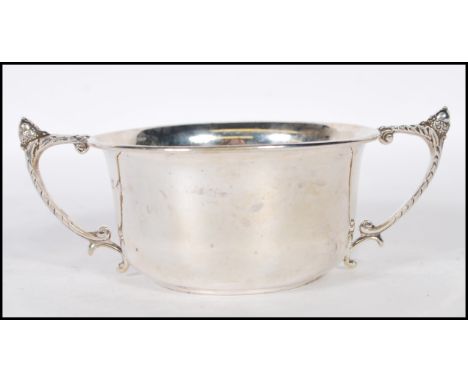 A silver hallmarked twin handled pedestal bowl, scroll handles with acorn finial, Birmingham assay, makers mark for&nbsp;Will