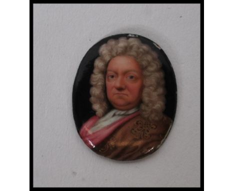 A 19th Century hand enamelled portrait miniature on metal of oval form depicting a Georgian gentleman in a wig, with gilt det
