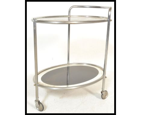 An early 20th Century Art Deco chrome and glass two tier drinks trolley. Each panel of oval form with mirrored glass finish t