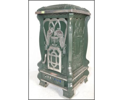 A large 20th century faux French painted green and silver upright pedestal room&nbsp; heater in the form of a woodburner, all