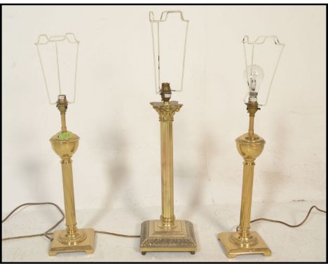 A pair of reeded column table lamps being of brass construction with neo classical doric columns on square bases&nbsp; togeth