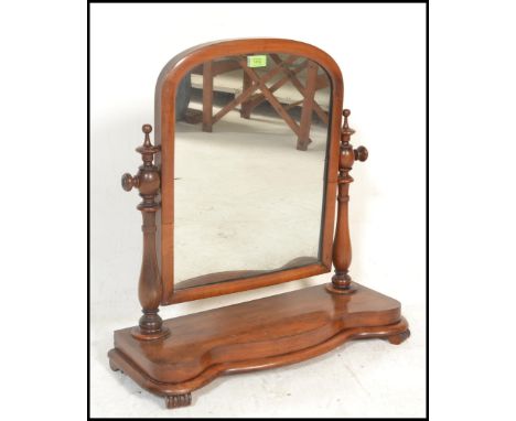 A 19th Century Victorian mahogany dressing table swing mirror of&nbsp; arch form, raised on shaped base with turned upright s