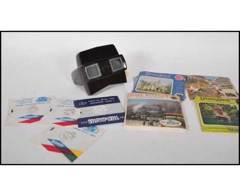 A vintage 20th Century bakelite Viewmaster slide viewer together with a selection of slide cards to include Walt Disney, Ali 