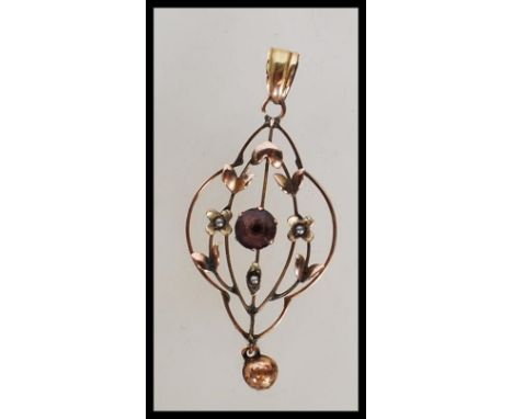 A 19th Century Victorian marked 9ct gold open work pendant set with seed pearls and a central Amethyst stone with floral deco