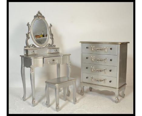 A contemporary French silvered commode chest of drawers with matching dressing table and stool. Each with embellished details