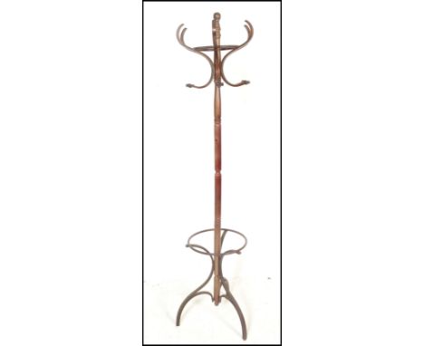 A Thonet style 20th century bentwood hat stand with shaped base and hoop stick stand having hooks atop.&nbsp;