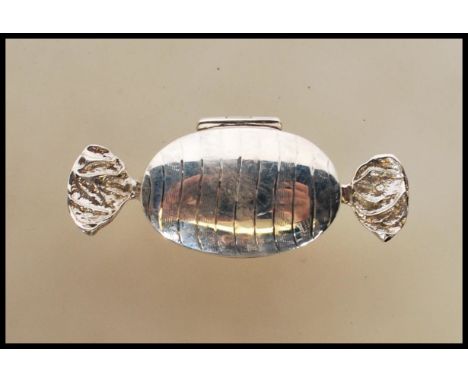 A contemporary designer white metal 925 silver pill / snuff box in the form of a wrapped sweet being stamped 925. L6cms long.