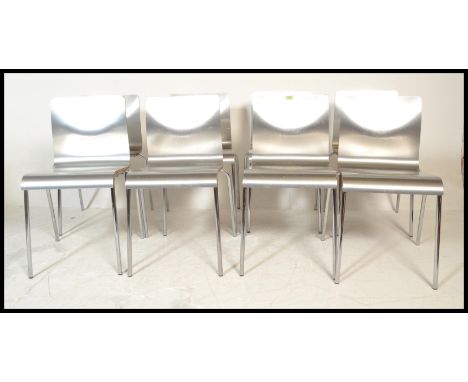 A set of eight panel stacking dining&nbsp; chairs, the chairs panels having a silvered finish raised on chrome tubular suppor