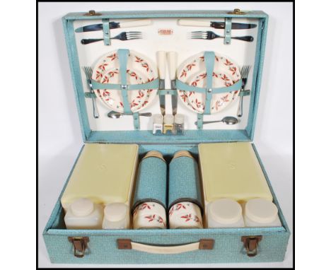 A vintage mid 20th Century Sirram picnic set hamper for four. Carry handle to the front of the hinged case opening to reveal 