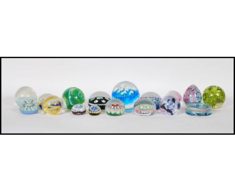 A good collection of retro vintage 20th Century studio art glass paperweights including Caithness, Strathern, Dartington, Mil
