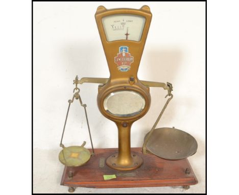 A set of vintage 20th Century shop grocery balance scales, gilt body with glazed dial to the top, mirror panel with notation 