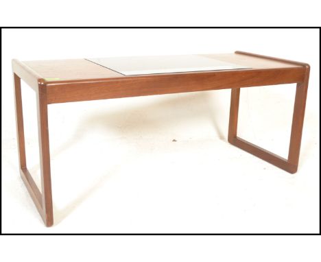 A mid century, Danish influence teak wood coffee rectangular long john coffee table. Raised on shaped legs, the rectangular t