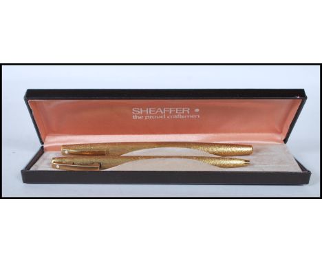 A set of two vintage Sheaffer 1970's writing pens to include a 14ct gold nib fountain pen and a mechanical ballpoint pen, bot