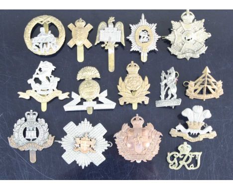 A collection of cap badges and insignia to include Royal Leicestershire Regiment, Army Ordnance Corps, Lancaster King's Own R