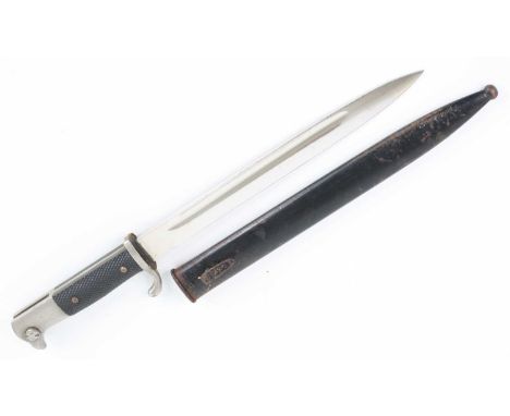A German Third Reich K98 dress bayonet, having a 25cm single edged fullered blade with chequered two piece grips, housed in a