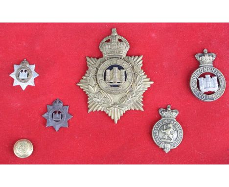 A Devonshire Regiment helmet plate, circa 1881-1901, together with five Devonshire Regiment glengarry, cap badges and button.