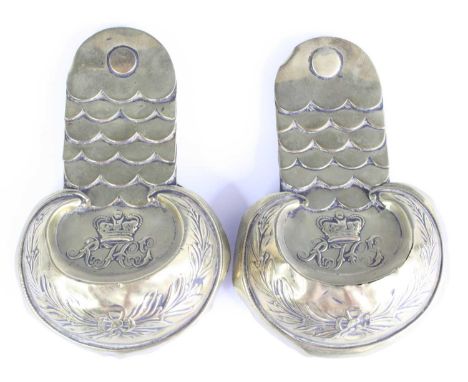 A pair of Victorian brass epaulettes for the Royal Horse Guards, each with a crown above R.H.A with scales above and wreath b