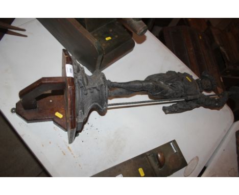 A large spelter lamp figure mounted on a wooden wall bracket