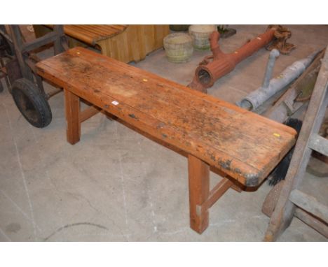 A large wooden bench, (possibly pig killing bench)