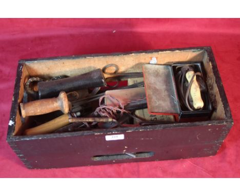 A box containing a quantity of haberdashers tools and irons 