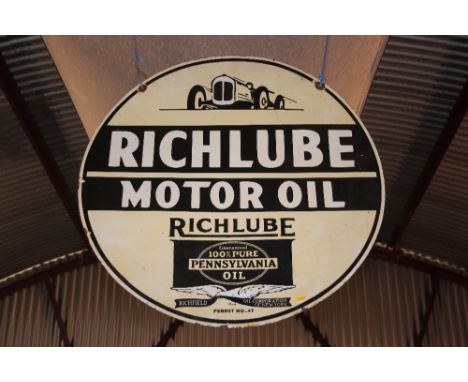 A "Richlube Motor Oil" circular enamel double sided advertising sign, 30" dia. approx.